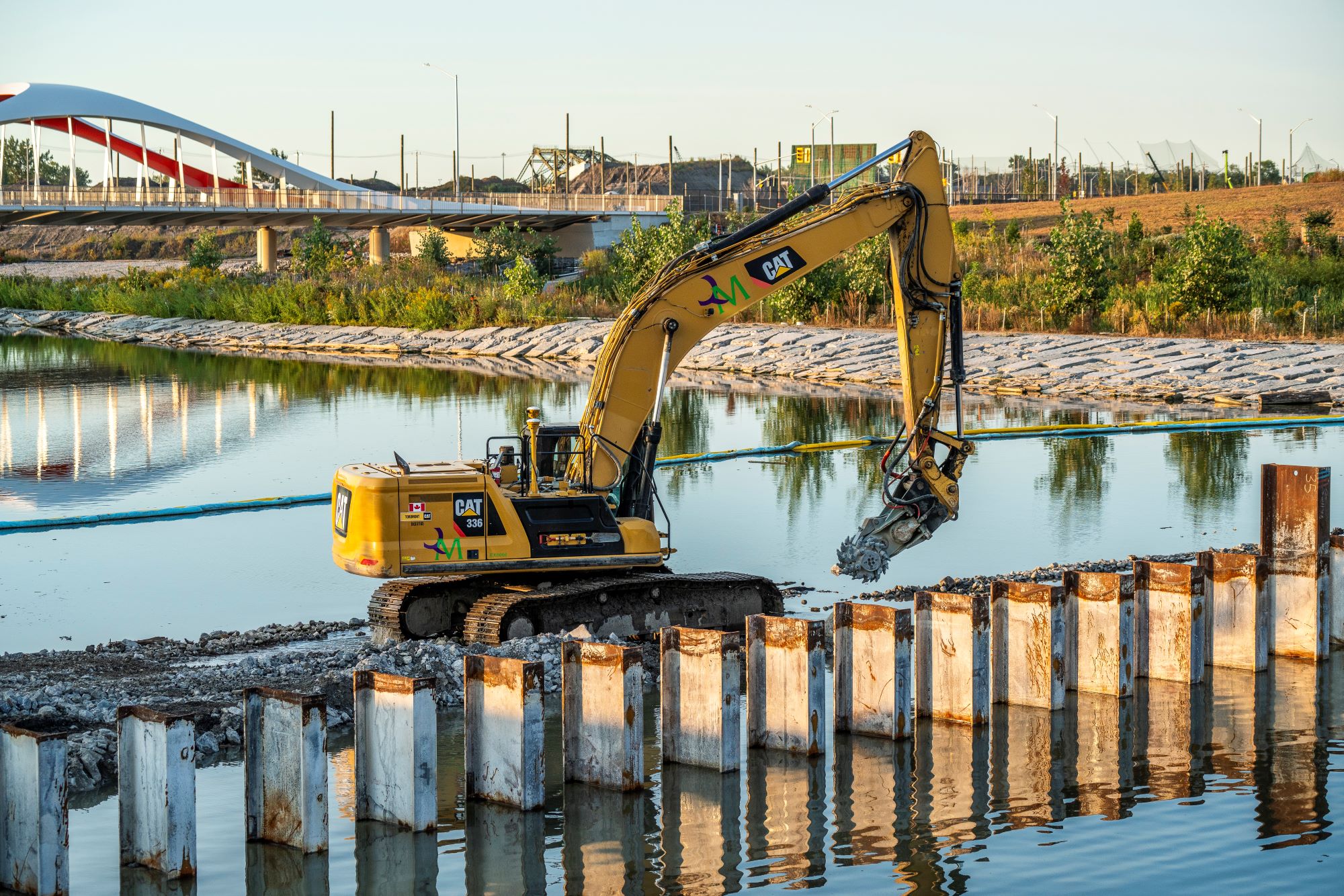 An excavator using a grinder attachment removing the north plug. /Waterfront Toronto, Vid Ingelevics/Ryan Walker